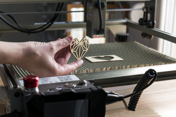 laser engraving cutting woman holding example cut out wooden heart laser engraving cutting woman holding example cut out wooden heart
