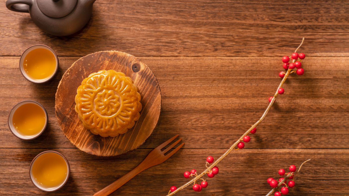 chinese traditional pastry moon cake mooncake with tea cups bamboo serving tray wooden background midautumn festival top view flat lay 1